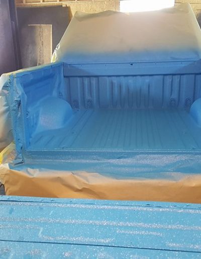 Bed of truck with customized spray-in bedliner in Carolina Blue color.